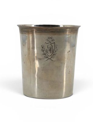 an old silver cup with a crest on the side