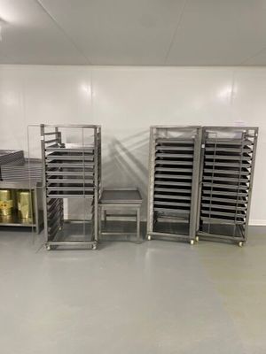 many trays of food on the shelves in the kitchen