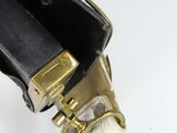 a black and gold purse that is open on a white surface