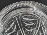 a glass plate with a design on it on a black surface