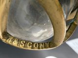 a close up of a glass vase with a gold handle