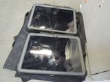 two pieces of luggage sitting on the floor next to each other