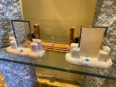 a glass table with a mirror and some items on it