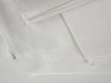 a close up of a pile of white towels on a table