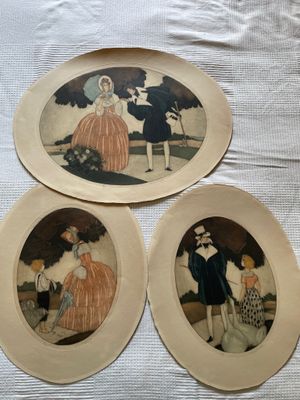 three plates with pictures of people on them sitting on a table