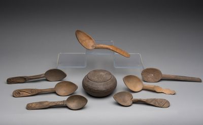 many wooden spoons and spoons sitting on a table