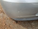 a close up of a car ' s front bumper with a hole in it