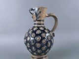 a blue and white vase with a gold decoration on it