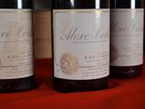 three bottles of wine are lined up on a table