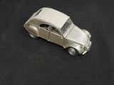 a toy car that is sitting on a black surface