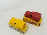two toy cars sitting next to each other on a white surface