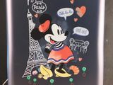 a suitcase with a mickey mouse sticker on it
