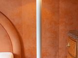 a lamp that is sitting on the floor next to a bed