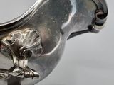 an antique silver plated sugar dish with a bird on it
