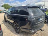 a black range rover parked in a lot with other cars