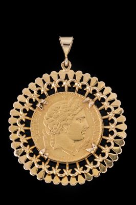 un pendentif en forme de pièce d'or, avec une tête de femme au centre