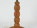 a wooden table lamp that has a cord attached to it