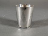 a silver cup that is sitting on a table