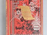 an old red book with black and white flowers on it
