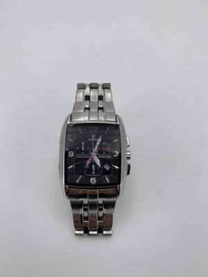 a close up of a watch on a white surface with a white background