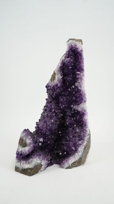 a close up of a piece of amethorate on a white surface