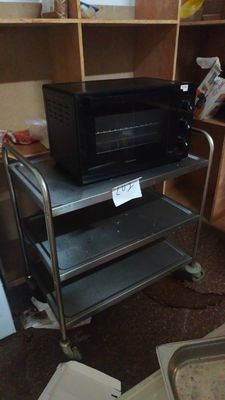 a microwave sitting on top of a cart in a kitchen