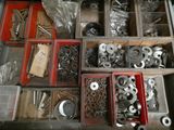 many different types of metal parts in a drawer