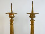 two gold candles that are sitting on a table