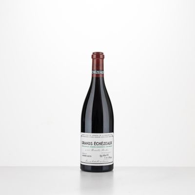 a bottle of red wine sitting on top of a table