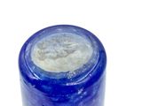 a glass jar with a blue lid on a white surface