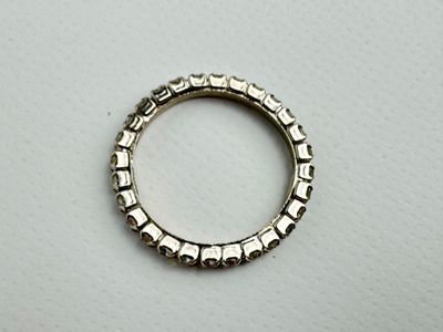 gros plan d'une bague en argent sur une surface blanche
