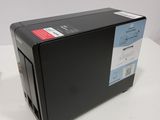 an image of a black printer sitting on top of a white table