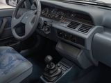dashboard of a car with blue seats and a steering wheel