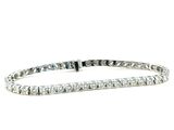 a white gold tennis bracelet with a row of diamonds