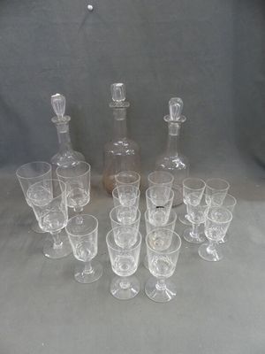 bottles and glasses are lined up in a circle on a table