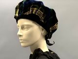 a mannequin wearing a black dress and a blue hat