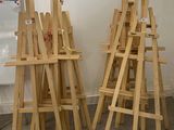 three easels that are standing up in a room