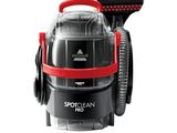 a close up of a black and red vacuum cleaner on a white background