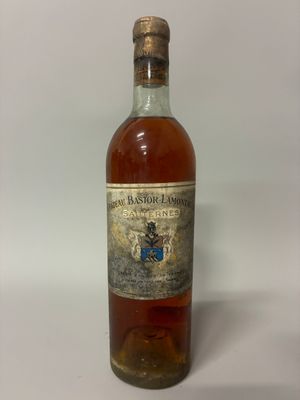 an old bottle of whiskey sitting on top of a white table