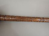 a wooden baseball bat with writing on it sitting on a table