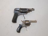 two revolvers that are on a white surface
