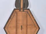 a small wooden instrument that is sitting on a white surface