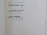 an open book with a poem on it on a table