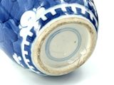 an image of a blue and white vase on a white surface