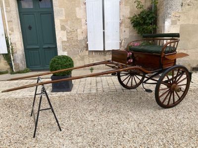 a horse drawn carriage parked in front of a building