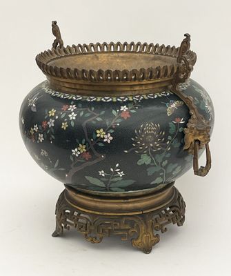 a large vase with a bird on it on a stand