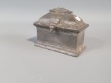 a small silver box sitting on a white surface