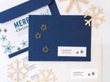 a close up of a blue envelope with snowflakes on it