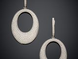 a pair of diamond and white gold earrings