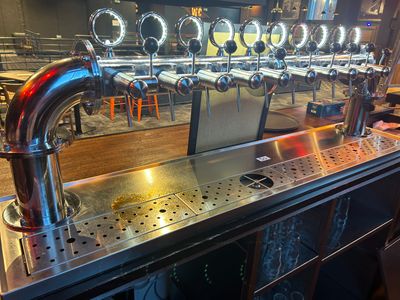 a picture of a bar with a bunch of beer taps